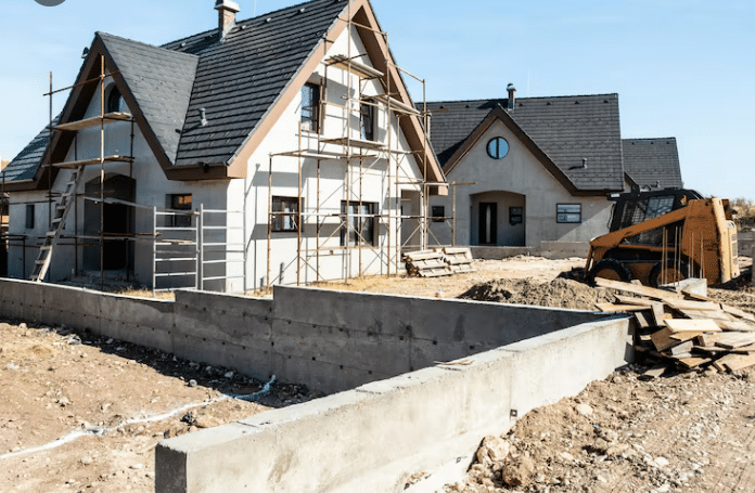 New home under construction with scaffolding and building equipment