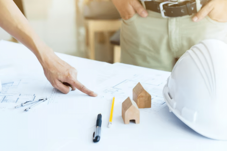 Architects reviewing blueprints and miniature house models