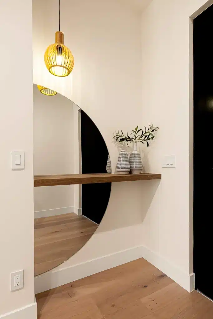 Modern entryway with floating console and round mirror