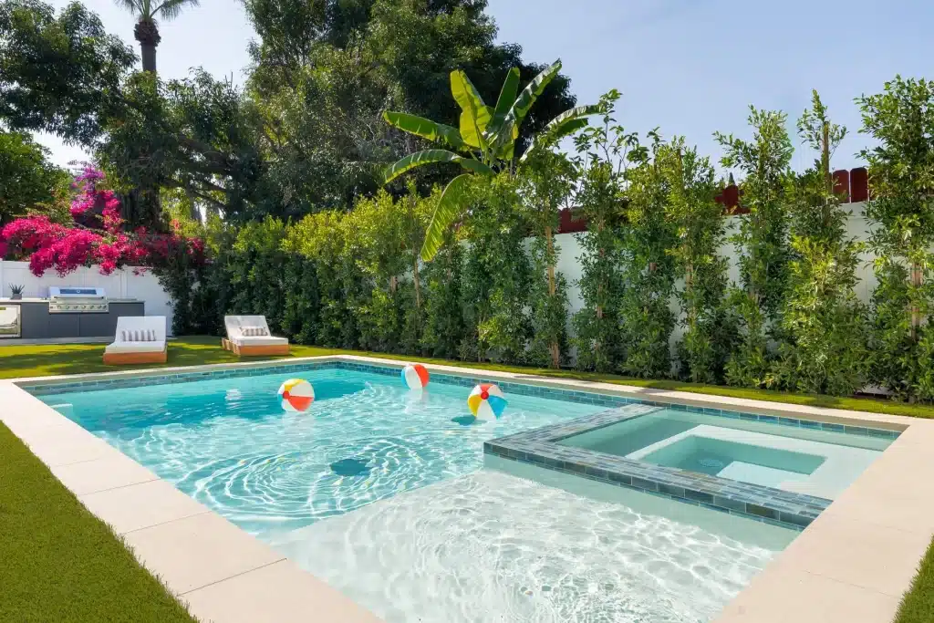 Contemporary swimming pool with tropical landscaping