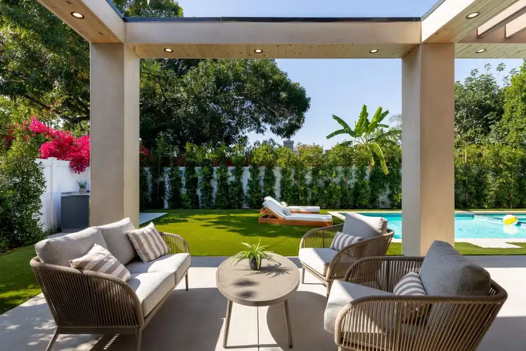 Covered patio overlooking pool and backyard
