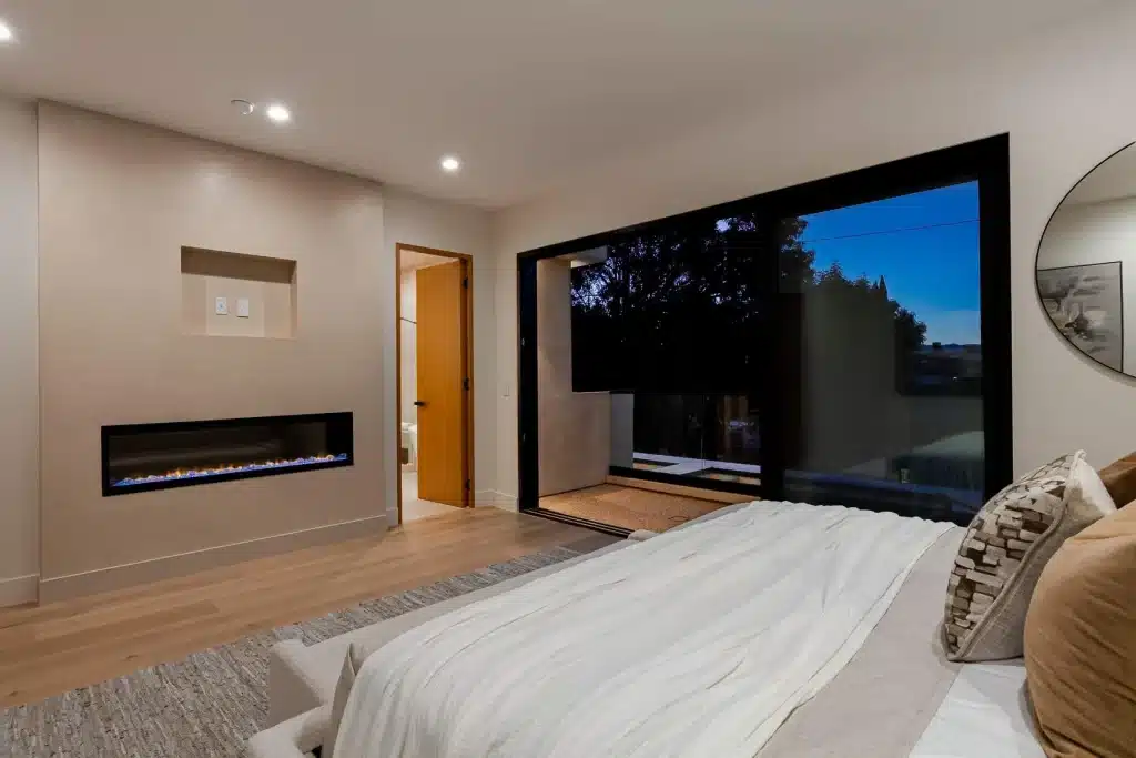 Luxury bedroom with fireplace and balcony