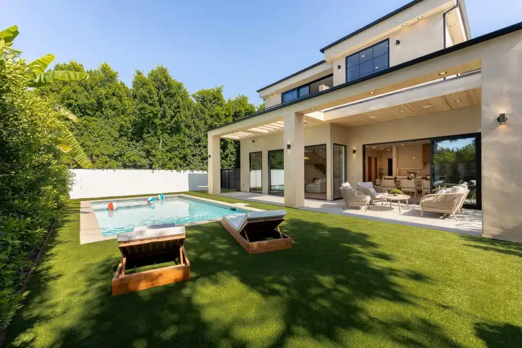 Luxury backyard with pool, patio, and modern home