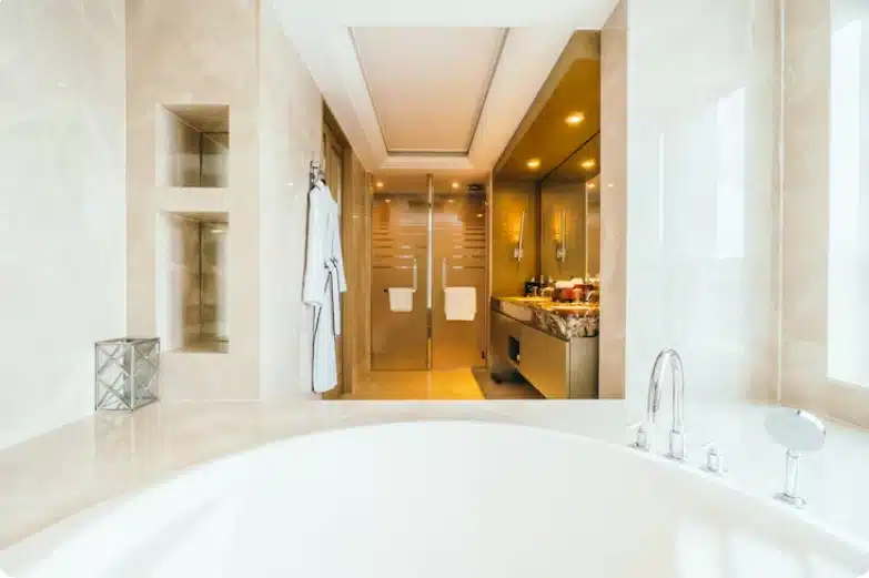 Luxury bathroom with soaking tub, marble finishes, glass shower enclosure, and custom vanity.