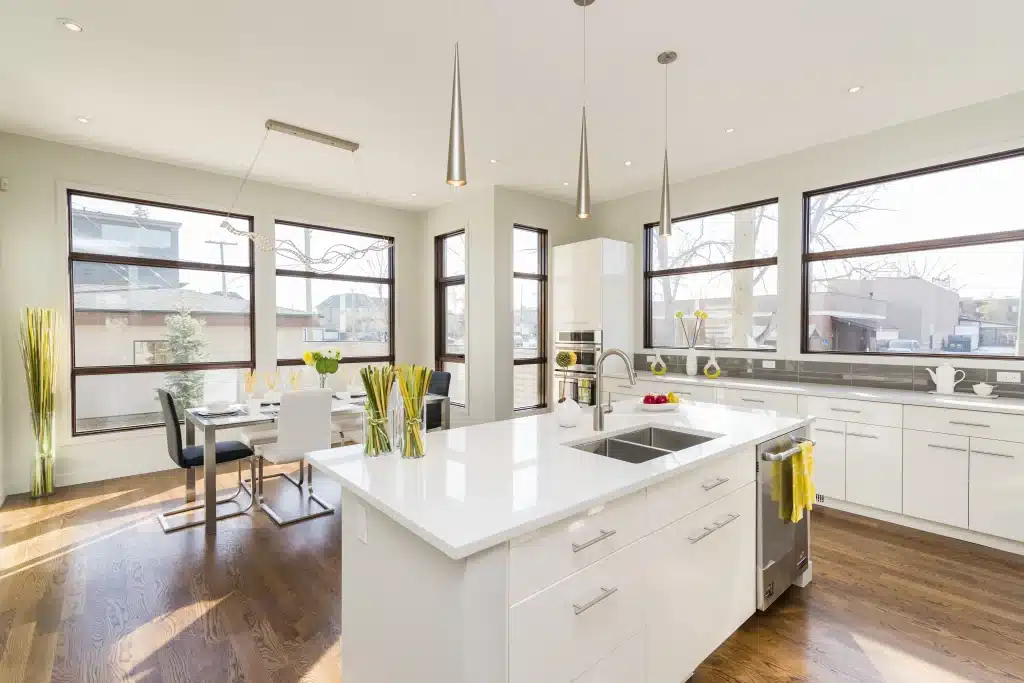 Contemporary kitchen with dark wood cabinets, waterfall island, pendant lighting, and hardwood floors.